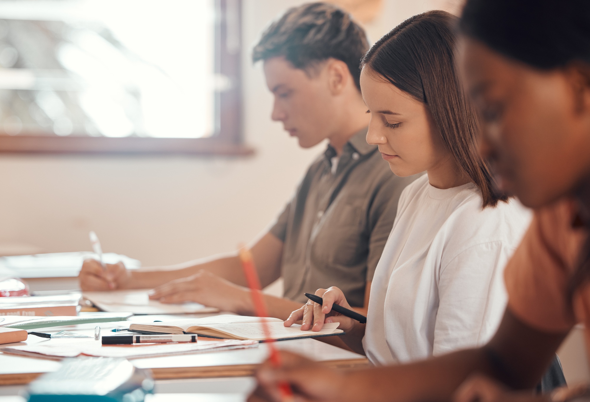 Education, writing and exam with students in classroom of college for academy, knowledge and learni